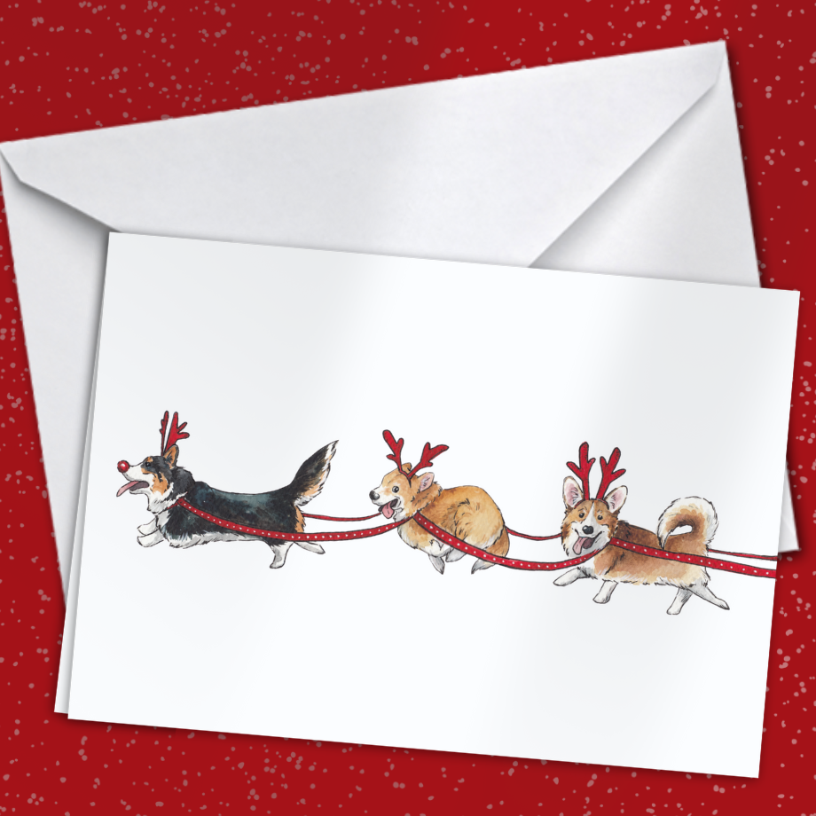 Greeting card with three dogs wearing reindeer antlers on a red background